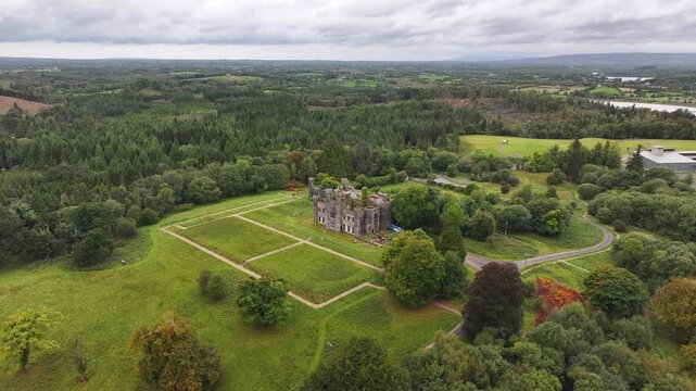 Drone reveal of Castle Saunderson in Co Cavan with park and forest by the river. Ireland