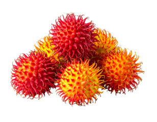Pile of red, spiky fruits with yellow tips against a black background