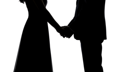 Silhouetted figures of two individuals holding hands. The light outlines their forms, creating a dramatic, romantic scene against a dark background