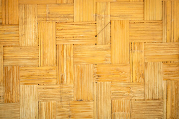 Natural bamboo texture with woven pattern, showcasing warm yellow tones and rustic charm. Ideal for backgrounds or eco friendly designs