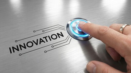 Finger pressing illuminated blue activation button labeled innovation on a brushed metal surface signaling a new beginning or technological launch