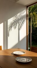 Palm shadows dance across a dining room wall in golden hour light