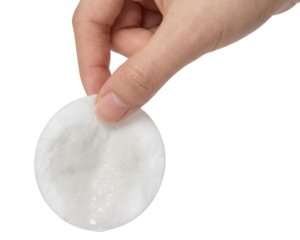 Hand holding a cotton pad isolated on white background.