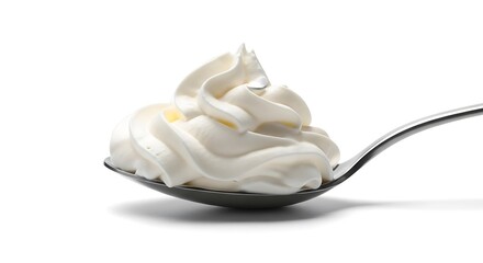 Swirl of whipped topping rests delicately on the bowl of a metallic spoon against a white background