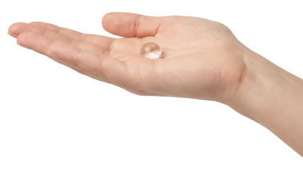 Hand Holding Small Clear Glass Sphere, Isolated on White