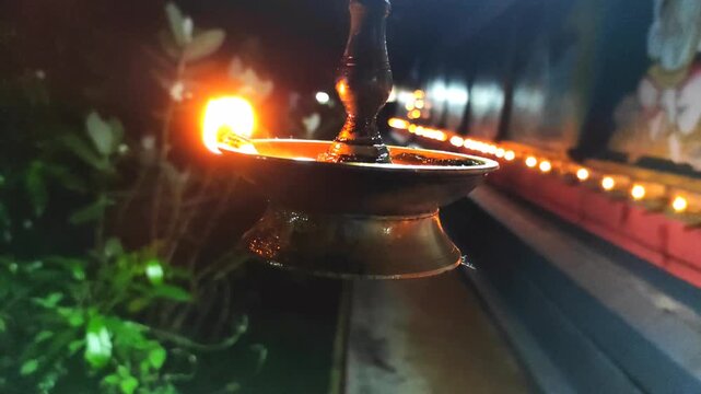 Traditional brass Oil Lamp With Warm Flame at Night in Shiva Temple, Palakkad, Kerala, India