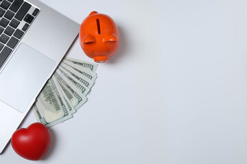 Fototapeta premium Piggy bank, money on the table, top view. 