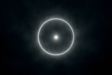 Glowing circular light ring floating in dark space creating a mysterious abstract cosmic atmosphere.