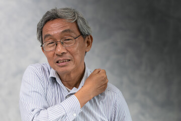Senior business man suffering shoulder pain, office syndrome hand massaging with space for text