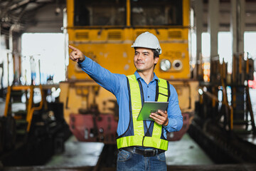 Portrait locomotive service maintenance engineer staff worker male confident in train depot.