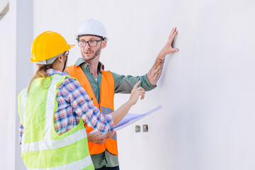 Professional builder team working check progress construction of the wall structure of the building.