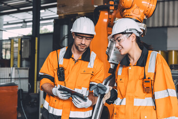 Engineer team service robot welding working in automation factory