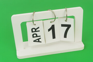 April 17 on calendar on green background