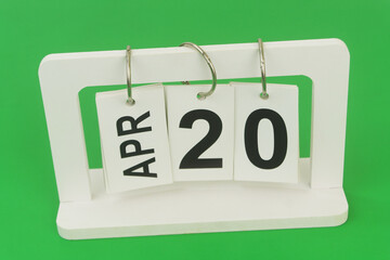 April 20 on calendar on green background