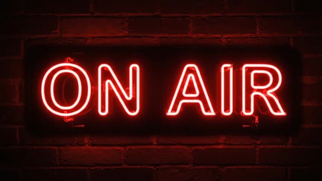 Neon sign displaying 'ON AIR' illuminates a brick wall in a dimly lit setting, creating a vibrant and inviting atmosphere for broadcasting