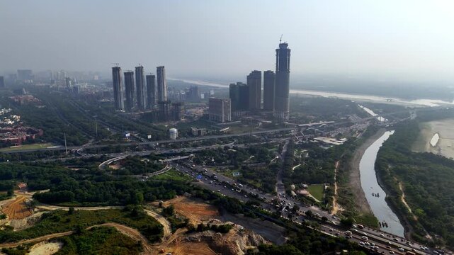Noida from above famous super nova emerging towers pierce the hazy horizon as roads, rivers, and greenery weave together, reflecting a city in transition toward a vertical future.