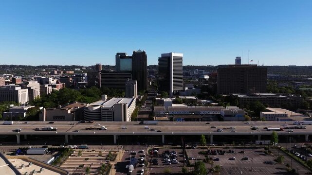 Wide aerial of downtown Birmingham crossing interstate 20 and dense city blocks, pullback panoramic overview convention center