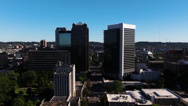 Smooth aerial ascend of downtown Birmingham, buildings on 19th street north