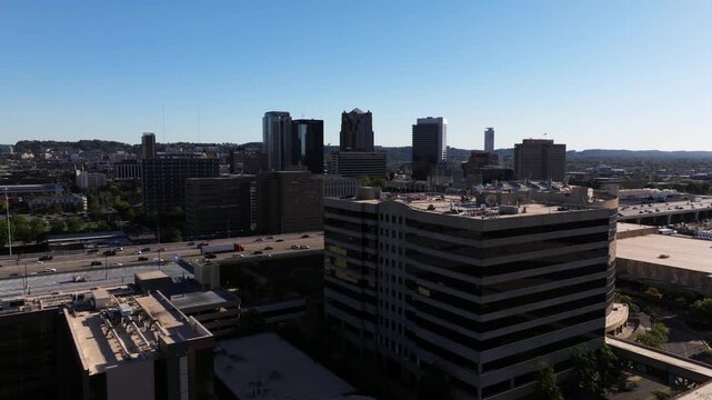 Aerial transition from Birmingham Jefferson Convention Complex toward downtown skyline and nearby interstate corridor, establish