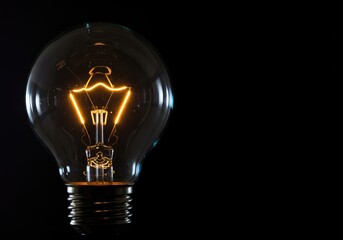 Glowing electric bulb showing strong reflections on the curved glass surface, symbolizing innovation, energy, and brilliant concepts ,focus ,reflection ,industrial