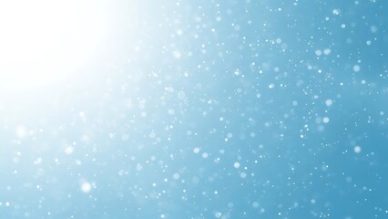 Snow falling on blue background with sunlight falling snow snowflakes