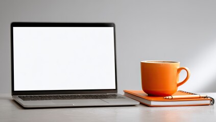 Laptop, coffee cup, and notebook on a desk