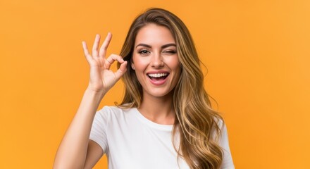 Fototapeta premium Woman Winking Making Ok Gesture Over Orange Background