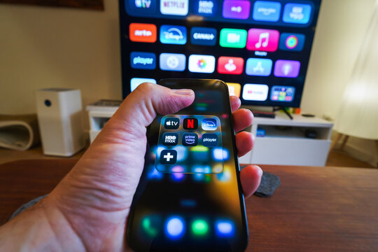 Poznań, Poland, 01 January 2026, Streaming platforms icon home entertainment smartphone television remote control living room