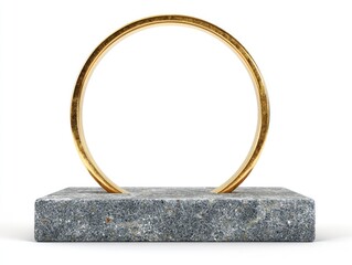 Golden ring sculpture on gray stone block isolated against white background