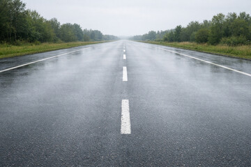 Empty wet asphalt road background with copy space