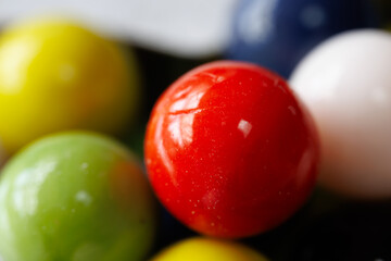 A close up of a red and green marble