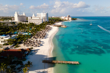 Experience the vibrant turquoise waters and soft white sands of Noord, Aruba. Luxurious resorts line the coastline, inviting travelers for unforgettable holidays in this tropical Caribbean escape.