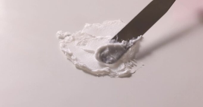 Cosmetic Cream Texture Spread with Spatula for Skincare Product Research