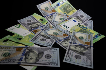 US dollars and euro banknotes scattered as money background