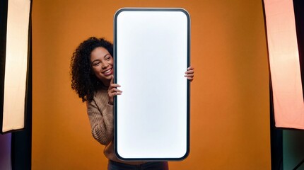 Smiling woman peeking from behind giant blank smartphone screen for app or content promotion