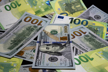 Obraz premium US dollars and euro banknotes scattered as money background