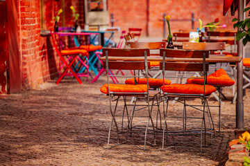 Bright chairs and tables create a vibrant, inviting atmosphere in a lively plaza