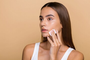 Young Woman Applying Cleansing Wipe on Face - Skincare Routine