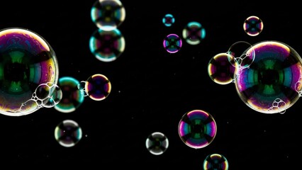 iridescent soap bubbles floating on black background with colorful reflections abstract macro photography for design