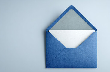 Blue textured paper envelope with white paper inside, partially open