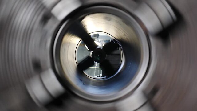 Heavy industry concept. Drilling process on industrial lathe machine. shavings in industrial workshop. rotating shafts in industrial setting. rotating metal part. metal part spinning. 4 k video
