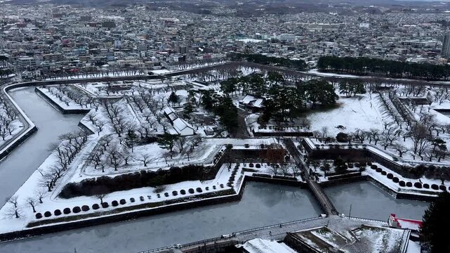Historic snow covered fortress and moat in an aerial city view