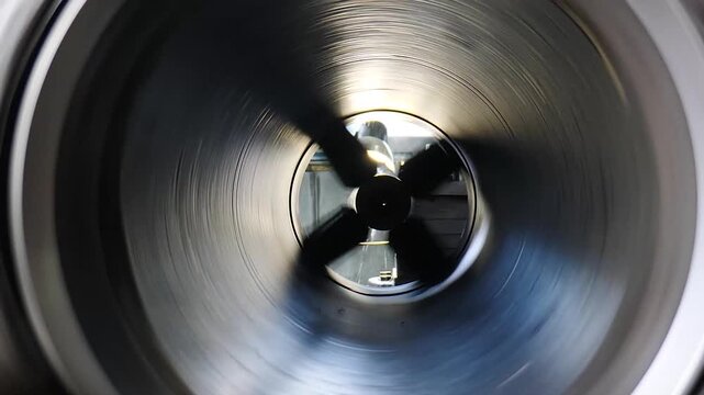 Heavy industry concept. Drilling process on industrial lathe machine. shavings in industrial workshop. rotating shafts in industrial setting. rotating metal part. metal part spinning. 4 k video