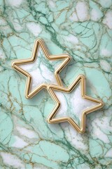 Two gold-framed white marble stars on a teal marble background