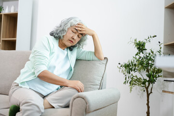 Depressed senior woman holding medication at home. Elderly mental health, loneliness, anxiety,...