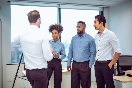 A confident female professional presents business data and charts during a team meeting. The scene highlights leadership, communication skills, diversity, and in a modern corporate environment. - Powered by Adobe