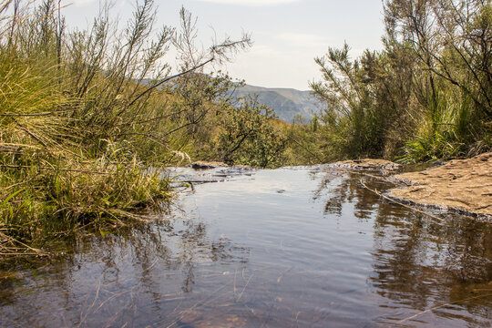 A small mountain stream, just before a rapid, forming a small infinity pool, in the Drakensberg Mountains, South Africa