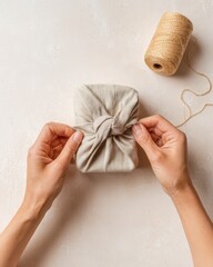 Gift Wrapping With Fabric and String at a Workspace