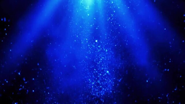 Abstract deep blue water with light rays and bubbles creating a mystical underwater scene