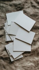 Blank white business cards scattered on a textured fabric background. Concept Blank Business Cards, Textured Fabric Background, Flat Lay Photography, Minimalist Office Theme, White Cards on Texture